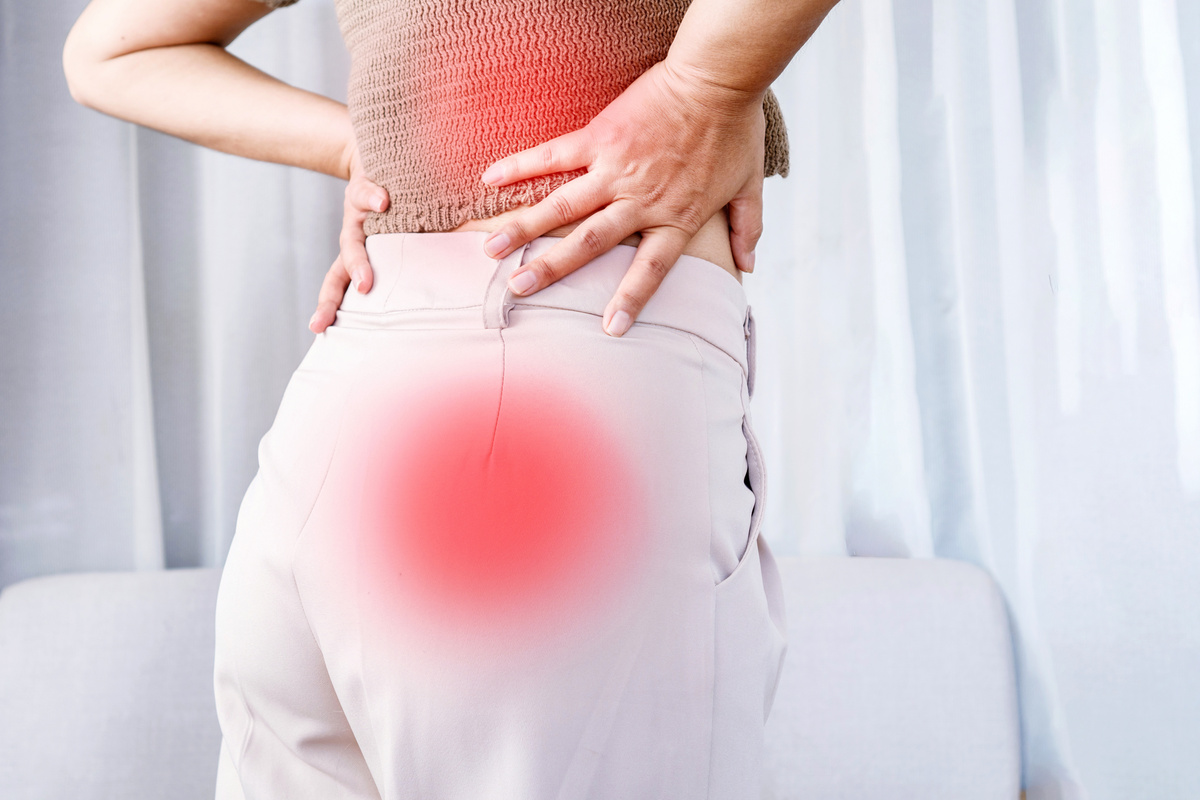 woman suffering from lower back pain spreading to , Sciatica pain concept